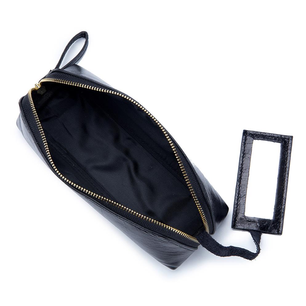 Portable female hand holding cosmetic bag