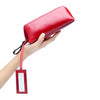 Portable female hand holding cosmetic bag